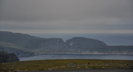 Landscape view of mountain and sea at MagerÃ¸ya island in Finnmark county on the way to North Cape (Nordkapp) at midnight time in Norwayの写真素材
