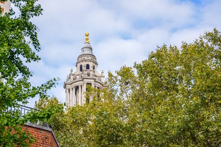 Top of Saint Paul's Cathedral through trees on Ludgate Hill at the highest point of the Cityの写真素材
