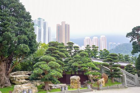 Nan Lian Garden, a Chinese classical garden in Diamond Hill with hills,  trees, rocks and wooden structures, Hong Kongのeditorial素材