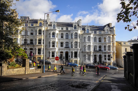Locals walking and crossing the street in the morning in the town of Douglas, Isle of Man