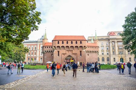 Tourists visiting Krakow Barbican, a historic fortified outpost gateway leading into the Old Town of Krakow, Polandのeditorial素材