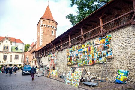 Outdoor hanging paintings gallery selling for tourists at St. Florian's Gate, a famous tourists attraction in Krakow, Polandのeditorial素材