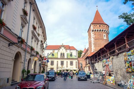 Tourists and locals spending their time at St. Florian's Gate, the Polish gothic city defense walls with medieval towers and a focal point of Krakow's Old Town, Polandのeditorial素材