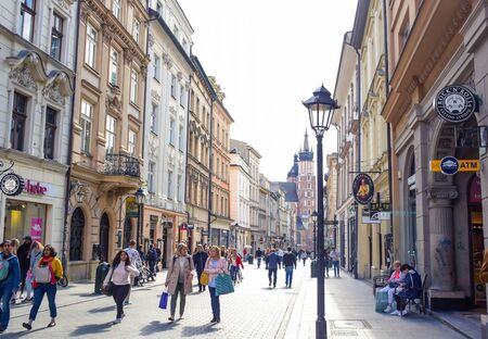 Tourists walking through Florianska street with St. Mary's Basilica church in background, the main streets in Krakow Old Town and one of the most famous streets of Krakow, Polandのeditorial素材