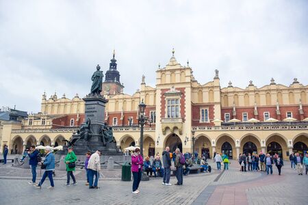 Tourists enjoying their time at Main Square located at Krakow's Old Town with Cloth Hall and Adam Mickiewicz Monument, Polandのeditorial素材
