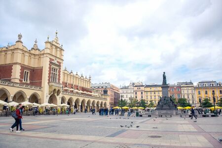 Krakow's Main Square (Rynek Glowny) with Cloth Hall and Adam Mickiewicz Monument located at center of the Old Town district in Lesser, Polandのeditorial素材