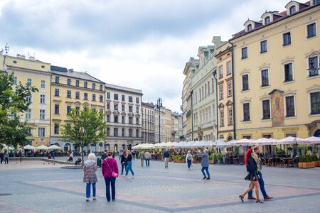 Tourists enjoying their time at Krakow's Main Square (Rynek Glowny) located at center of the Old Town district in Lesser, Polandのeditorial素材