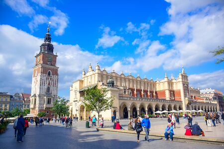 Tourists enjoying their time at Krakow's Cloth Hall and Town Hall Tower located at the center of main market square (Main Square) in the Krakow Old Town, Polandのeditorial素材