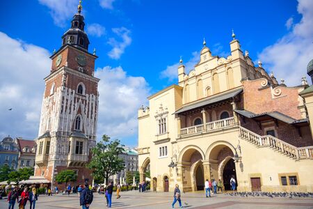 Tourists enjoying their time at Krakow's Cloth Hall and Town Hall Tower located at the center of main market square (Main Square) in the Krakow Old Town, Polandのeditorial素材