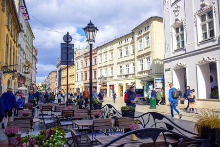 Tourists and Polish locals enjoying their time walking along the street in the city of Krakow, Polandのeditorial素材
