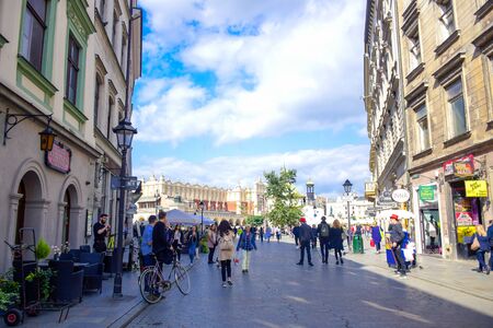 Tourists and Polish locals enjoying their time walking along the street in the city of Krakow, Polandのeditorial素材