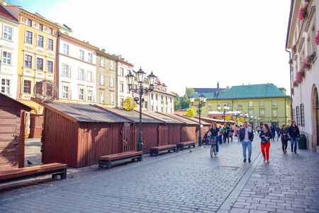 Tourists and Polish locals walking and strolling on the street in the city of Krakow, Polandのeditorial素材
