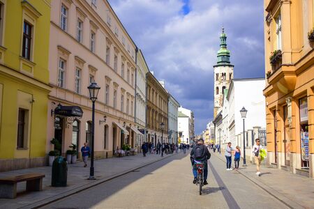 Tourists and Polish locals walking and strolling on the street in the city of Krakow, Polandのeditorial素材
