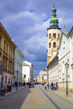 Tourists and Polish locals walking and strolling on the street in the city of Krakow, Polandのeditorial素材