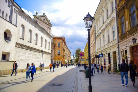 Tourists and Polish locals walking and strolling on the street in the city of Krakow, Polandのeditorial素材
