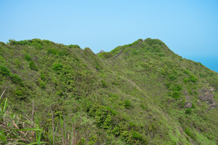 Natural green mountain and valley landscape scenic view of Bitou Cape (Bitoujiao) on a clear blue sky day in Ruifang district of New Taipei City, Taiwanの写真素材