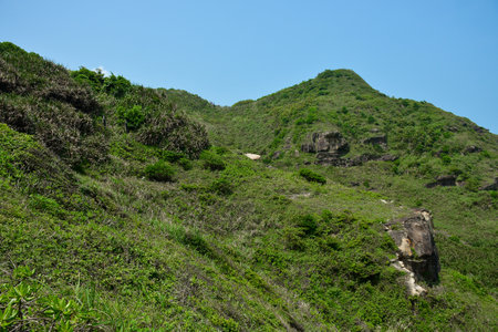 Natural green mountain and valley landscape scenic view of Bitou Cape (Bitoujiao) on a clear blue sky day in Ruifang district of New Taipei City, Taiwanの写真素材