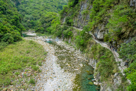 Shakadang Trail (Mysterious Valley Trail) through green mountain and turquoise water stream of...