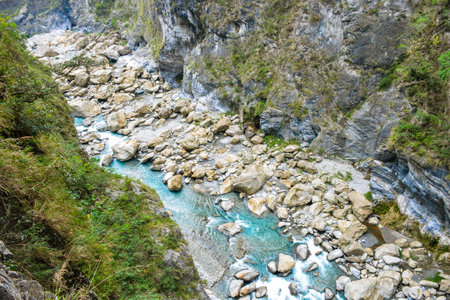Scenic view of Swallow Grotto Yanzikou Trail with narrow turquoise Liwu River Gorge and high mountain cliff face in Taroko National Park, Xiulin Township, Hualien, Taiwanの写真素材