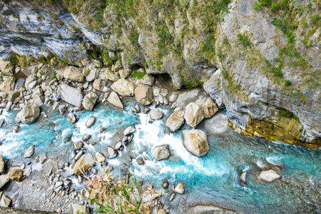 Scenic view of Swallow Grotto Yanzikou Trail with narrow turquoise Liwu River Gorge and high mountain cliff face in Taroko National Park, Xiulin Township, Hualien, Taiwanの写真素材