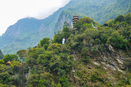 Chinese pagoda and Buddha statue at the top of mountain in Taroko National Park gorge in Hualien, Xiulin Township, Taiwanの写真素材