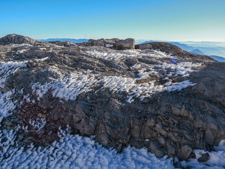 Mountain landscape with snow-capped peaks and clear blue skyの写真素材