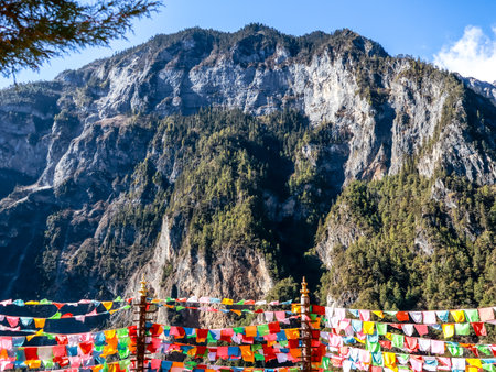 High Rocky Mountains Hills Valley With Colorful Tibetan Prayer Flags of Balagezong Grand Canyon National Scenic Park, Diqing, Shangri-La County of Yunnan, Chinaの写真素材