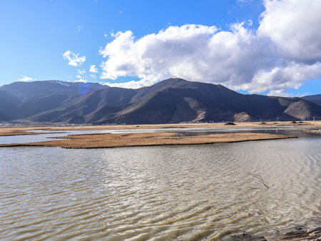 Napahai Grassland Scenic Area And Napahai Lake Surrounded by Snow-Capped Mountain In Shangri-La, Yunnan, Chinaの写真素材