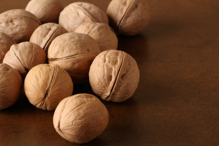 Still life with walnuts on a brown table in retro style