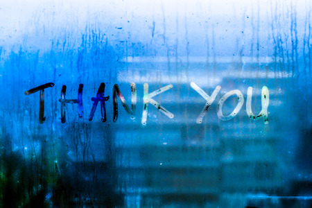 Thank you words rain drops water drops written wrie on window glass blue tone blur nature bokeh backgroundの写真素材