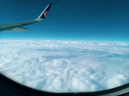 Aerial View from the Airplane Window Airplane Wing and Cloudsの写真素材