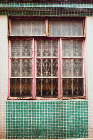 old vintage window of house old fashion design classic on green rustic mosaic on concrete wall backgroundの写真素材