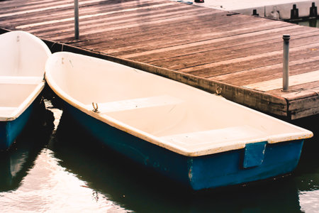 Boats at the wooden pier in  the lake nature recreation lifestyle backgroundの写真素材
