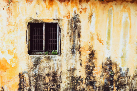 old vintage window of house old fashion design classic on yellow  rustic painted concrete wall backgroundの写真素材