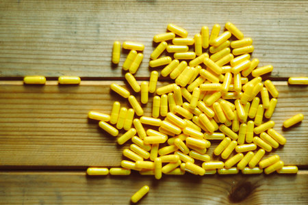 yellow pills and tablets capsules health concept idea background