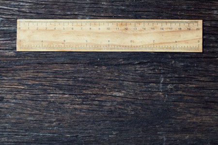 wooden rulers in centimeter and inch on old wood rustic background nature eco environment concept...