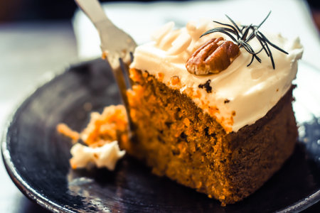 carrot cake with walnuts, prunes and dried apricots on a dark  background. tinting. selective focus...