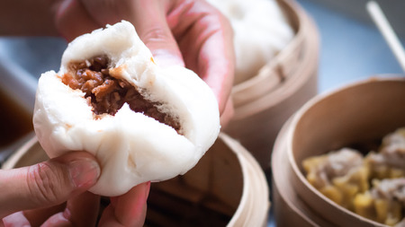Chinese BBQ Pork Buns served .Dim sum, traditional Chinese dumplings, in bamboo steamer basket. Asian foodの写真素材