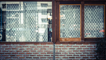 Old brick wall with brick and lovely window. white lattice curtain.