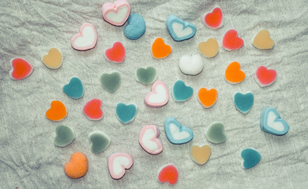 Heart Colorful sweets. Lollipops and candies. Top view backgroundの写真素材