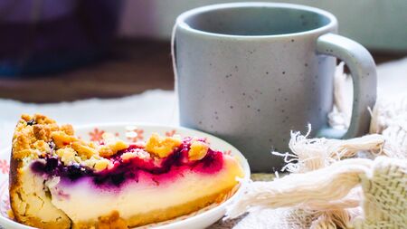 blueberry cheese cake on plate and a cup of coffee morning breakfastの写真素材