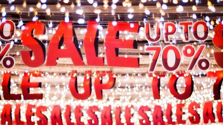 Store sale sign. Special offer banner with the red sale text gold bokeh blur backgroundの写真素材