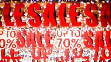 Store sale sign. Special offer banner with the red sale text gold bokeh blur backgroundの写真素材