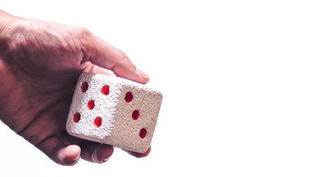 Hand & Rolling Dice. Hand rolls a dices on white isolated background. Selective focus. Dice is blur...