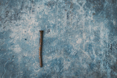 old rust nail on concrete background abstract construction business industry