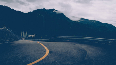 Curve along a Forest area Road in Autumn road to travel mountain