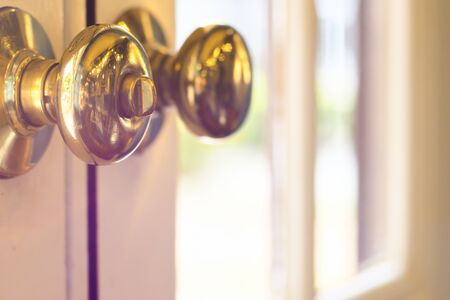 close up of metal handle on a old wooden door,golden door knob. close up of metal handle on a old wooden door,golden door knob.の写真素材