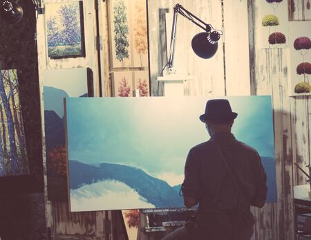 September 2019, cicada Hua Hin Market Thailand, flea market art and handmade products. A man is painting nature illustration picture.のeditorial素材