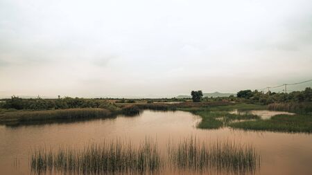 Beautiful landscape with a  calm evening landscape with lake and mountains in Prachubkeereekhan Thailandの写真素材