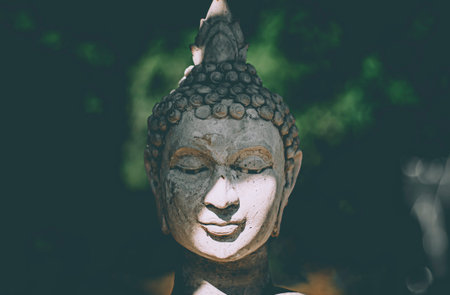 Statue of Buddha standing in meditation.Close up head face of statue Buddha.buddhism concept .peacefulness idea .lifestyle practise mind in clamnessの写真素材